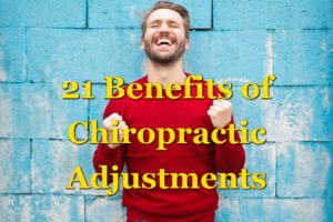 21 Benefits of Chiropractic Adjustments. An ecstatic man closing his eyes and smiling up at the sky while wearing a red long sleeve shirt and leaning back against a blue brick wall.